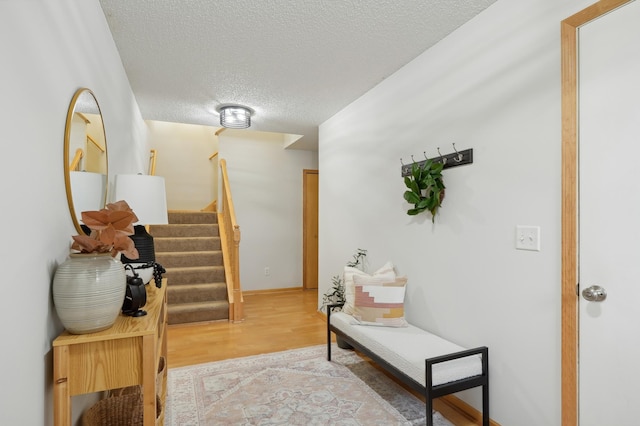 hallway with wood-type flooring and a textured ceiling