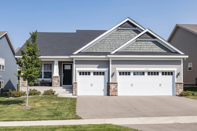 craftsman-style home with a garage and a front lawn