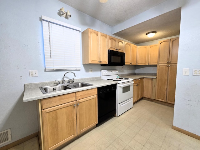 kitchen featuring black appliances, sink, and a textured ceiling