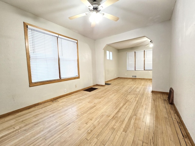 spare room with light wood-type flooring and ceiling fan