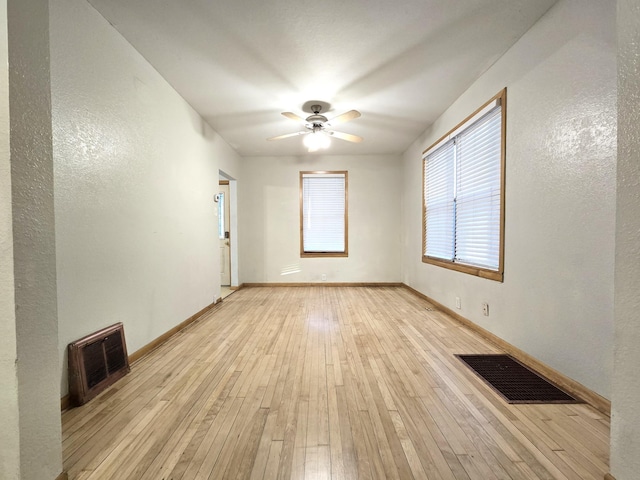 empty room featuring ceiling fan and light hardwood / wood-style flooring