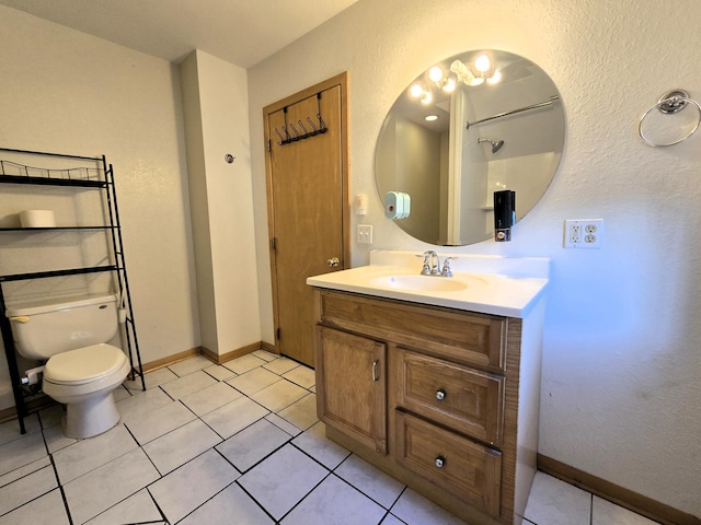 bathroom featuring tile patterned floors, vanity, and toilet