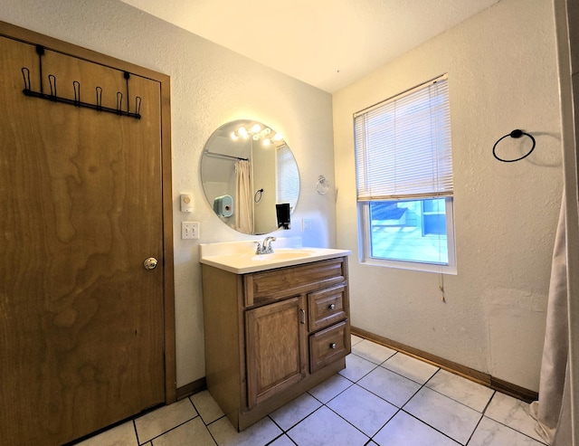 bathroom with tile patterned flooring and vanity