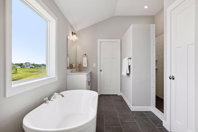 bathroom featuring tile patterned floors, vanity, lofted ceiling, and independent shower and bath