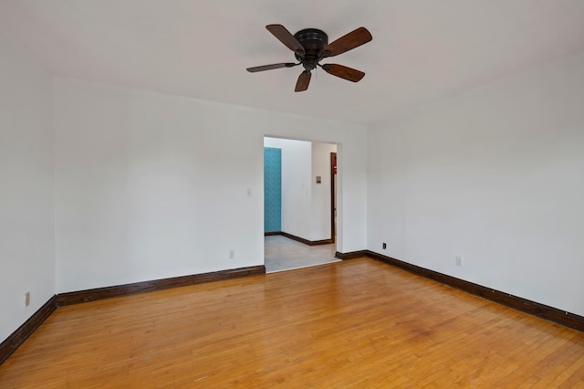 unfurnished room with light wood-style floors, baseboards, and ceiling fan