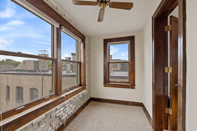 sunroom with a ceiling fan