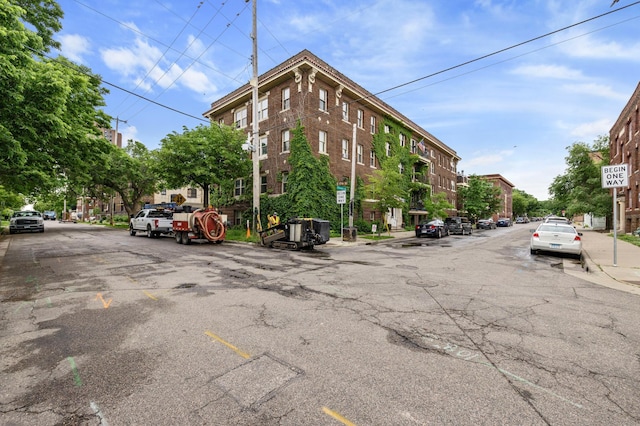 view of street with sidewalks, curbs, and traffic signs