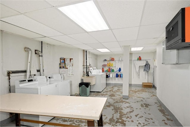 interior space featuring washer and clothes dryer, baseboards, and a sink