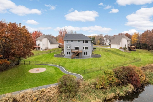 back of property featuring a yard and a deck