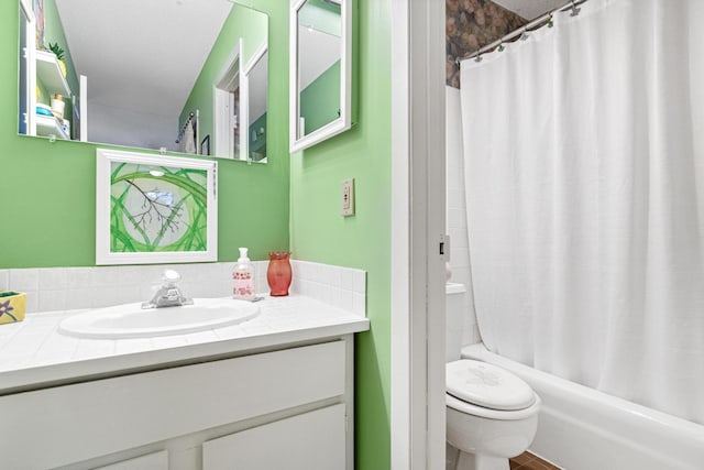 full bathroom with a textured ceiling, vanity, shower / tub combo, and toilet