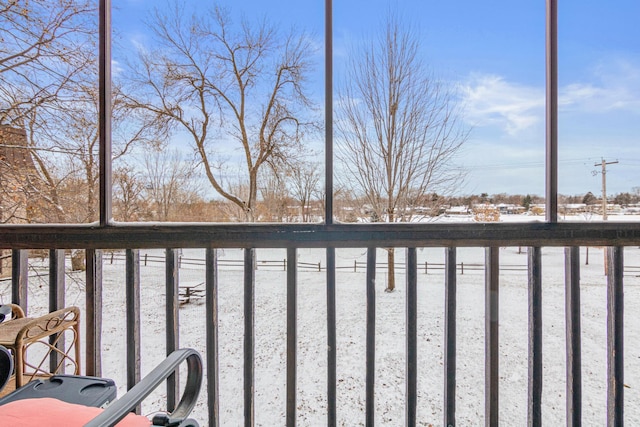 view of snow covered back of property