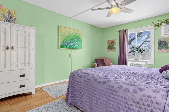 bedroom with ceiling fan and light hardwood / wood-style floors