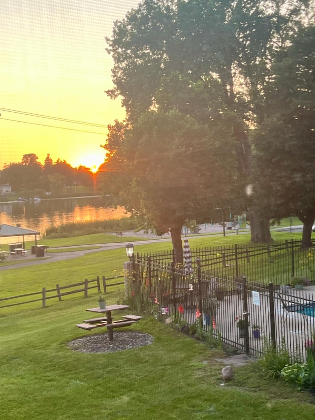 surrounding community featuring a yard and a water view