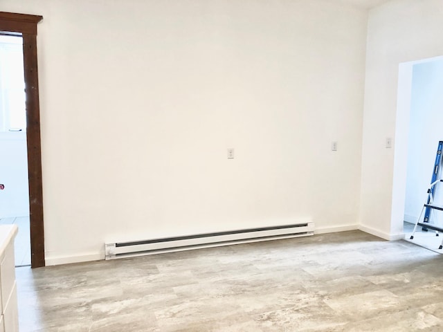 unfurnished room featuring a baseboard radiator