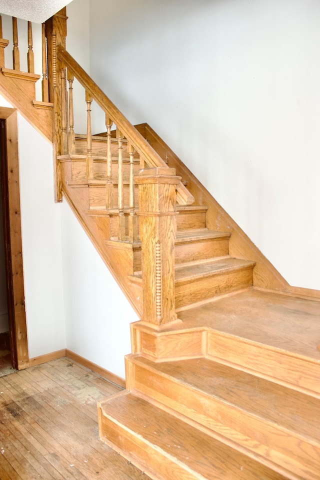 stairs with hardwood / wood-style flooring