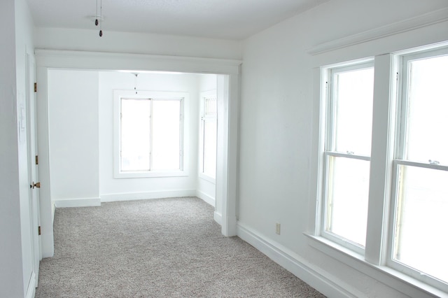 unfurnished room featuring light colored carpet