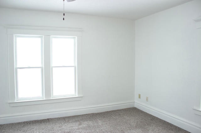 spare room featuring a healthy amount of sunlight and carpet floors