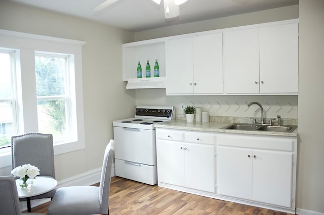 kitchen featuring exhaust hood, white cabinets, sink, light hardwood / wood-style flooring, and white range with electric stovetop