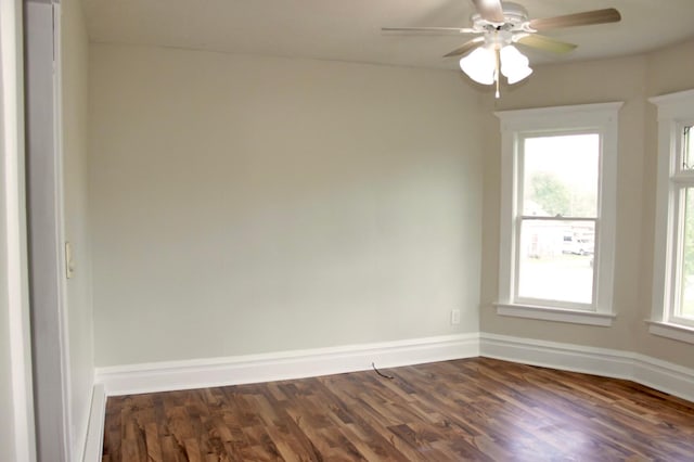 empty room with ceiling fan and dark wood-type flooring