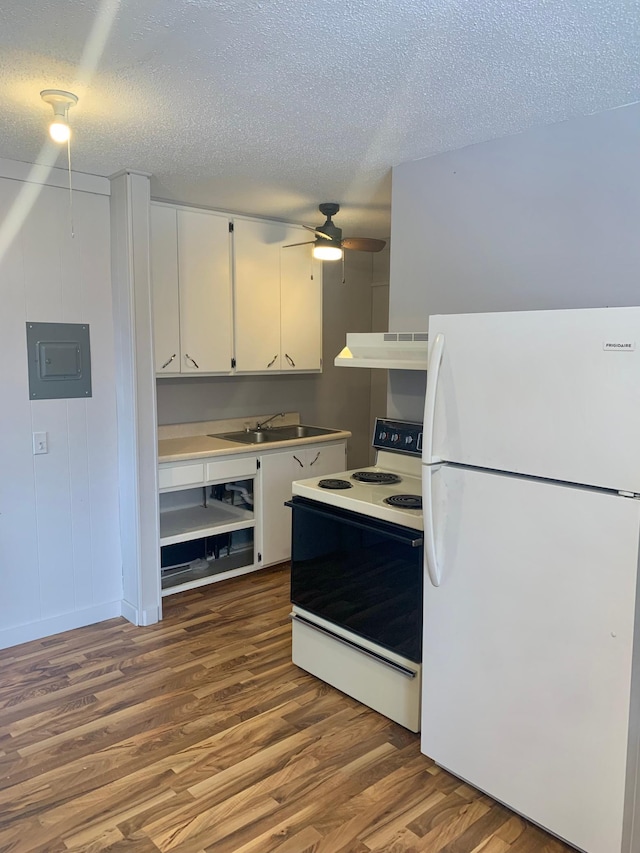 kitchen with white cabinetry, ventilation hood, a textured ceiling, white appliances, and hardwood / wood-style flooring