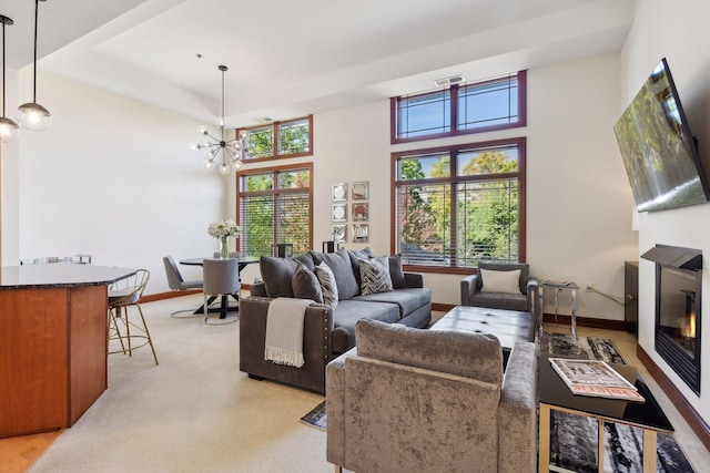 living room featuring a towering ceiling and an inviting chandelier