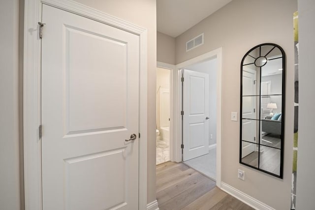 hallway with light hardwood / wood-style flooring