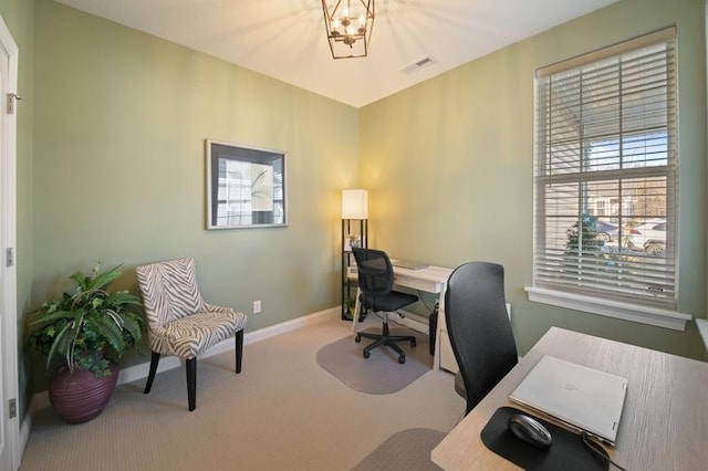 home office featuring an inviting chandelier and carpet floors