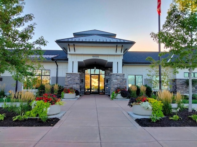 view of exterior entry at dusk