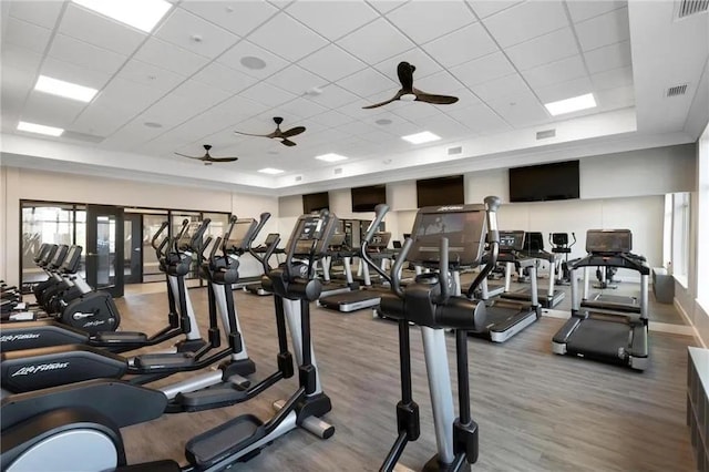 gym featuring wood-type flooring and a drop ceiling