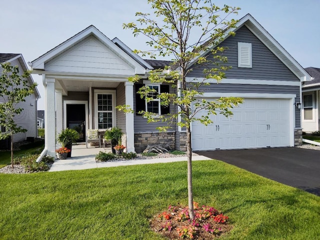 craftsman inspired home with a garage and a front lawn