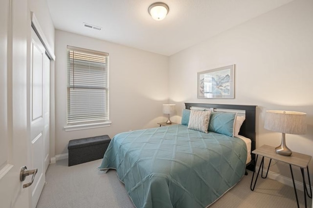 bedroom featuring light carpet