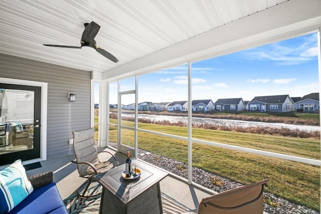 sunroom featuring ceiling fan