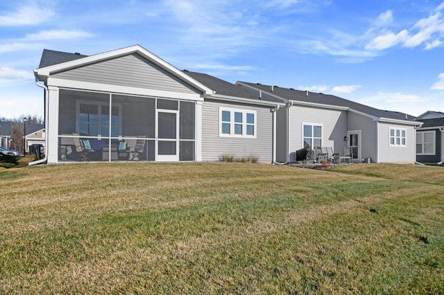 back of house featuring a sunroom and a yard