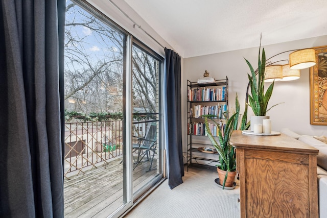 doorway to outside with light colored carpet