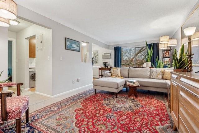 carpeted living room featuring washer / dryer and an AC wall unit