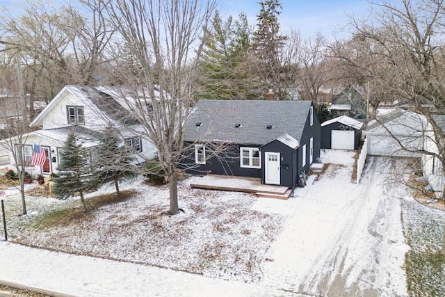 view of front of property with a garage and an outdoor structure