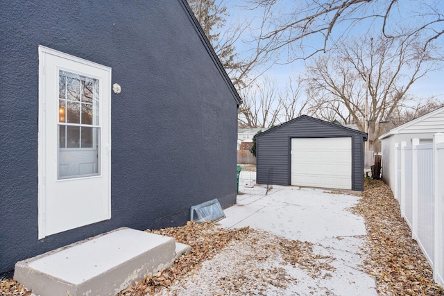 view of property exterior featuring a garage and an outbuilding