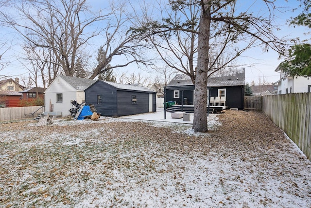 snowy yard featuring an outbuilding