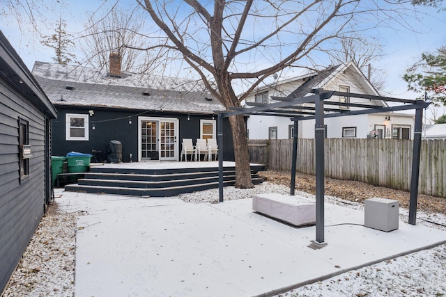 yard covered in snow featuring a patio and a wooden deck