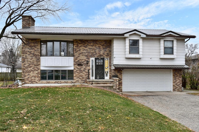 bi-level home with a front yard and a garage