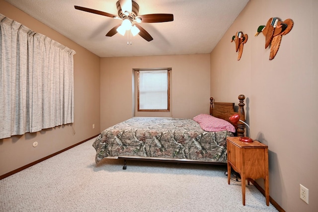 bedroom featuring ceiling fan, carpet, and a textured ceiling