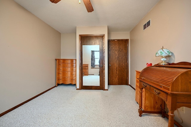 bedroom with ceiling fan and a textured ceiling