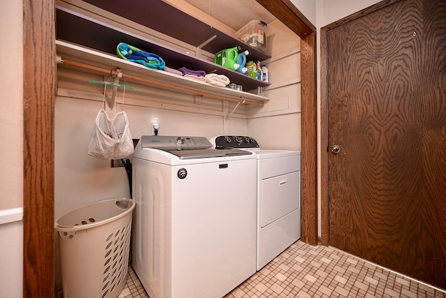 clothes washing area featuring washing machine and clothes dryer