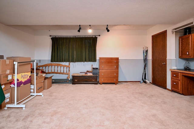 bedroom with light carpet and a textured ceiling