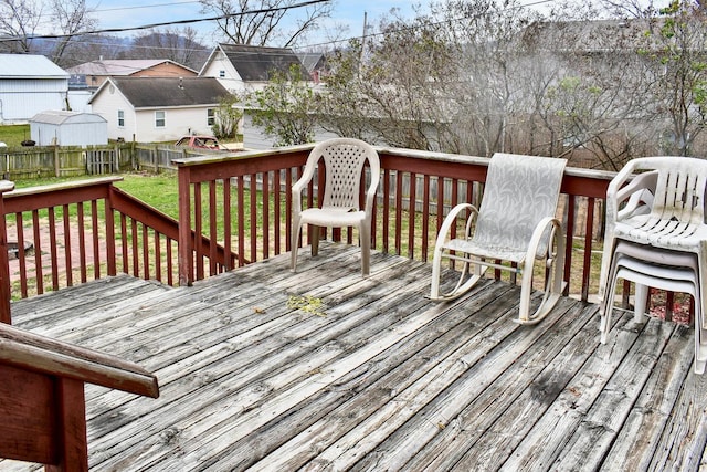 wooden terrace featuring a lawn