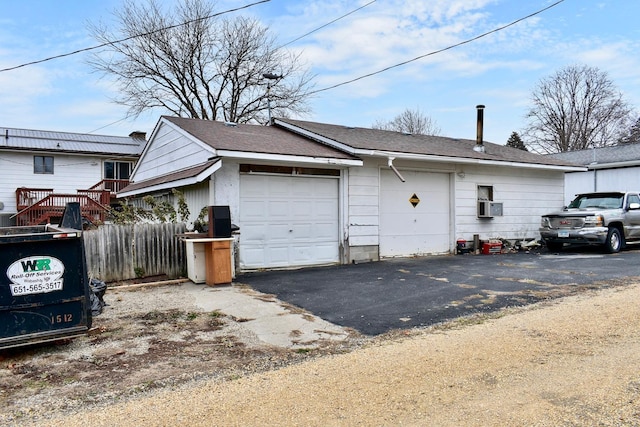 view of home's exterior with a garage and cooling unit