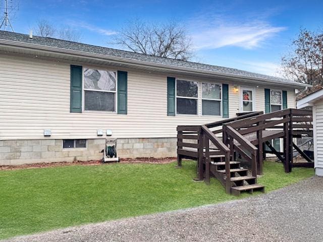 view of front of home with a front yard and a deck