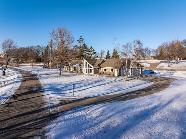 snow covered house with a garage