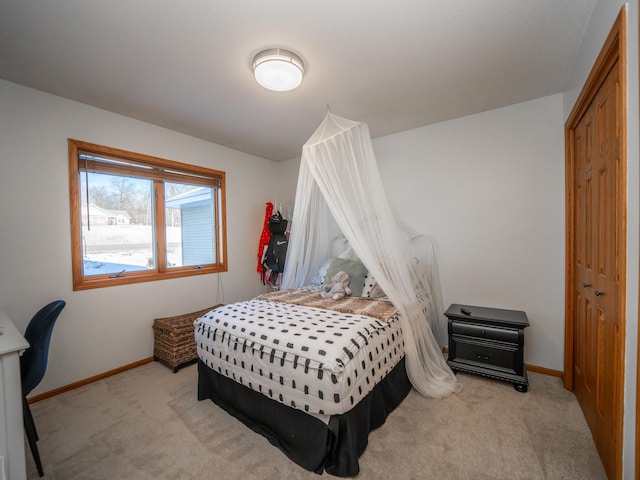 bedroom featuring light colored carpet and a closet