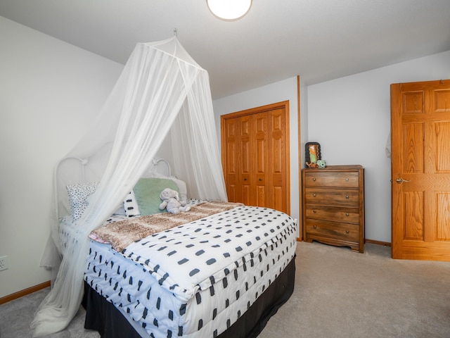 bedroom with light carpet and a closet